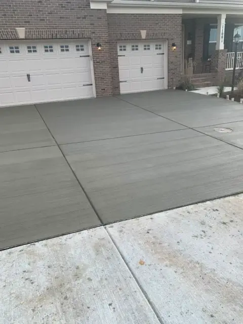 New concrete driveway with a clean broom finish by D&M Concrete in Virginia