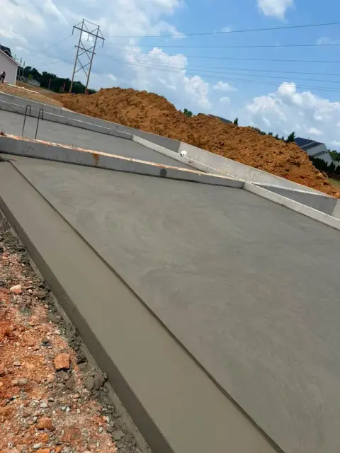 Wide concrete driveway leading to a home by D&M Concrete in Virginia
